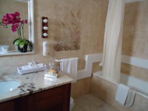 a bathroom with a sink and a toilet and a tub at Boutique Hotel Marina S. Roque in Lagos +43 photos