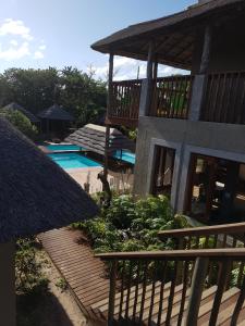 a house with a deck and a swimming pool at Kosi Bay Lodge in Manguzi