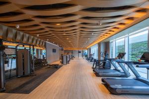 a gym with a row of treadmills and ellipticals at Wyndham Garden Jinjiang in Jinjiang