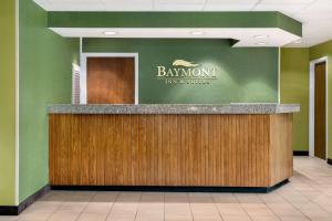 a lobby with a bar with a sign on the wall at Baymont by Wyndham North Dartmouth in North Dartmouth