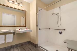 a bathroom with a shower and a sink at Baymont by Wyndham North Dartmouth Fall River in North Dartmouth +25 photos