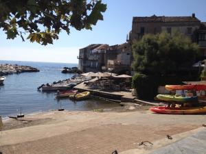 a group of boats are docked on the water at Erbalunga Magnifique t2 4pers in Brando