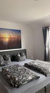 a bedroom with a bed with two pillows on it at Modernes 2 Zimmer Appartment in Göttingen