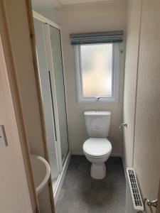 a small bathroom with a toilet and a window at Seton Sands Haven Holiday Village in Edinburgh +7 photos