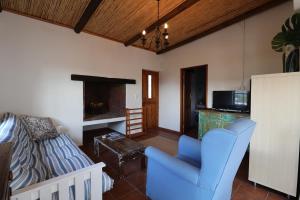 a living room with a couch and a chair at Hallo Jacobsbaai in Jacobs Bay