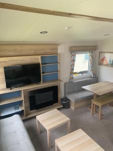 a living room with a flat screen tv and a couch at Seton Sands Haven Holiday Village in Edinburgh