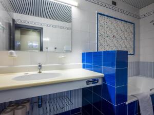 a bathroom with a sink and blue tiles at Hotel Leonardo Da Vinci in Limone sul Garda