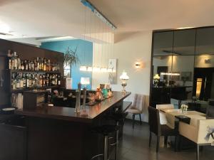 a bar in a restaurant with a counter and chairs at Onira Boutique in Tolo
