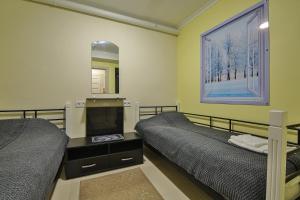 a bedroom with two beds and a mirror at Battle Mile Hostel in Cherkasy