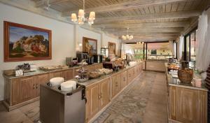 a large kitchen with wooden cabinets and a counter at Villaggio Maistro in Lefkada Town