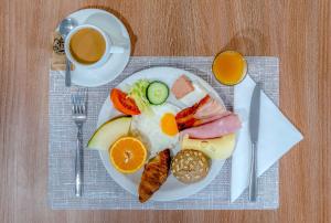 a plate of breakfast foods with a cup of coffee at Hotel Lanzarote Village in Puerto del Carmen