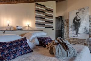 a bedroom with two beds and a painting on the wall at Be Vedetta - Relais & Glamping - Adult Only in Scarlino