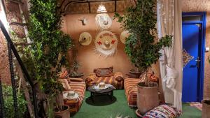 a living room with a couch and potted plants at Be Nomad in Marrakech