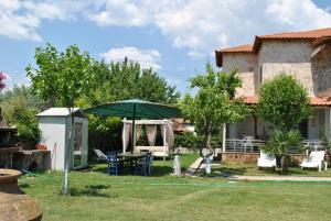 a yard with a table and an umbrella at Fernando in Ofrínion