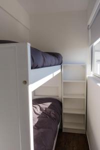 a bunk bed with a pillow on the bottom bunk at Peatonal Apart in Bahía Blanca