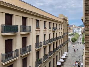 a view of a building with people walking on a street at Hostal Espoz y Mina in Pamplona