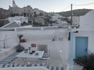 a view from the balcony of a house with a blue door at Casanova's house in Emporio Santorini