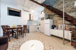 a kitchen and dining room with a table and a dining room at The Yellow House by MyRentalHost in Barcelona