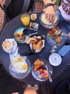a table with plates of breakfast foods on it at A23 Boutique Hotel in Tel Aviv
