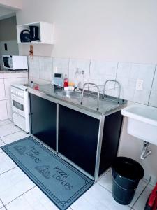 a kitchen with a counter with a sink and a sink at Residencial JOED 3 in Dourados