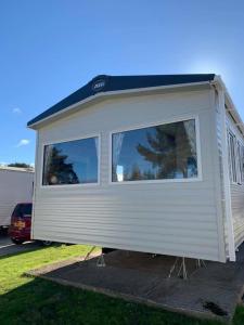 a large white trailer with a large window at Seton Sands Haven Holiday Village in Edinburgh