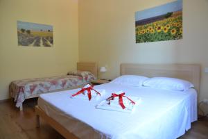 a bedroom with two beds with red bows on them at B&B Il Mondo Di Ross in Verona