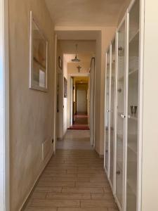 a hallway with glass doors and a tile floor at Tenuta Fagnanetto in Santo Stefano Belbo