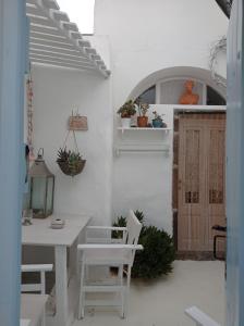 a white room with a white table and chairs at Casanova's house in Emporio Santorini
