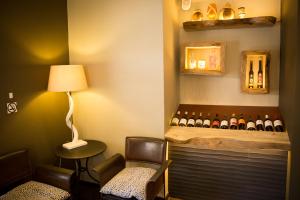 a waiting room with a bunch of wine bottles at Olive Grove Guesthouse in Windhoek