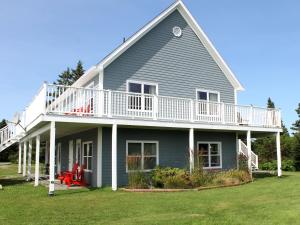 a large house with a porch and a deck at Seawind Landing Country Inn in Larrys River