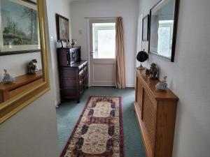 a room with a hallway with a door and a mirror at Sandy Retreat in Worle
