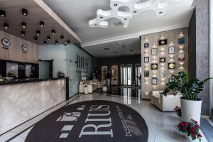 a lobby with a bar and a restaurant at Rius Hotel Lviv in Lviv