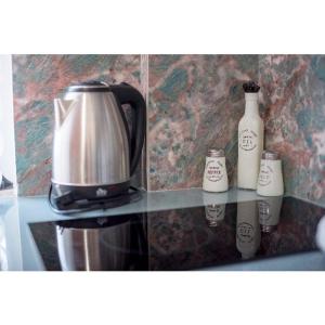 a coffee pot and two bottles on a counter at Paradisos in Preveza