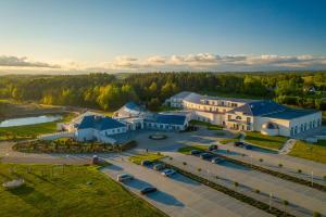 an aerial view of a large building with cars parked in a parking lot at Hotel Kiston in Sulęczyno