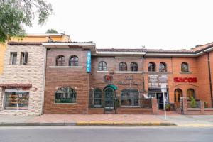 a brick building on the corner of a street at Ayenda Palermo Plaza in Bogotá