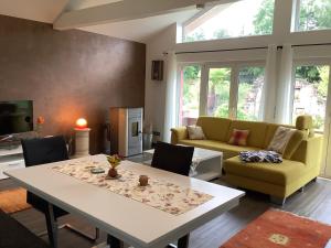uma sala de estar com uma mesa e um sofá em Ferienhaus Maar em Beckingen
