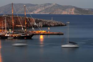 a group of boats docked at a dock in the water at Vrahos Boutique Hotel in Karavostasi