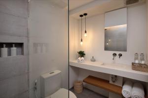 ein Badezimmer mit einem WC, einem Waschbecken und einem Spiegel in der Unterkunft Telescope Resort Lombok in Kuta Lombok
