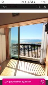 a room with a large window with a view of the ocean at Empuriabrava Vue Mer in Empuriabrava