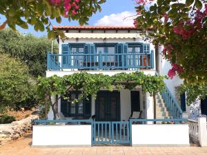 a blue and white house with a balcony at SAIL house in Skala Kallirakhis