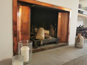 a fireplace with some objects on a table at Iona 4 bed luxury in the heart of Bracklesham Bay in Chichester