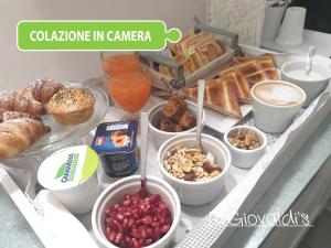 a tray with various breakfast foods on a table at B&B Giovaldi's Torino in Turin