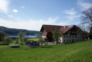 een groot gebouw met een speeltuin naast een groen veld bij Ferienhof Edtmeier in Zell am Moos