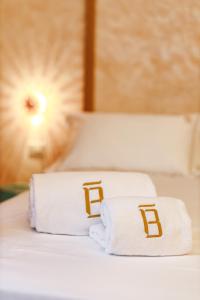 two towels sitting on top of a bed at BAYIT Charming Place in Polignano a Mare