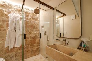 a bathroom with a sink and a mirror at BAYIT Charming Place in Polignano a Mare