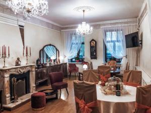a dining room with a table and a fireplace at Boutique Hotel RedHouse in Yaroslavl