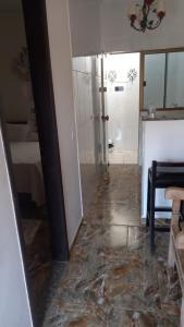 a living room with a marble floor and a bathroom at Pouso do Manu in Tiradentes
