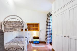 Posteľ alebo postele v izbe v ubytovaní Villa i Ginepri Villasimius località Porto sa ruxi