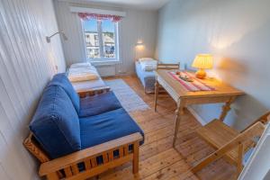 a living room with a couch and a table at Lofoten Å Hostel in Å