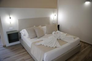 Postel nebo postele na pokoji v ubytování Oasi Guzzetta Hotel&Case Vacanze